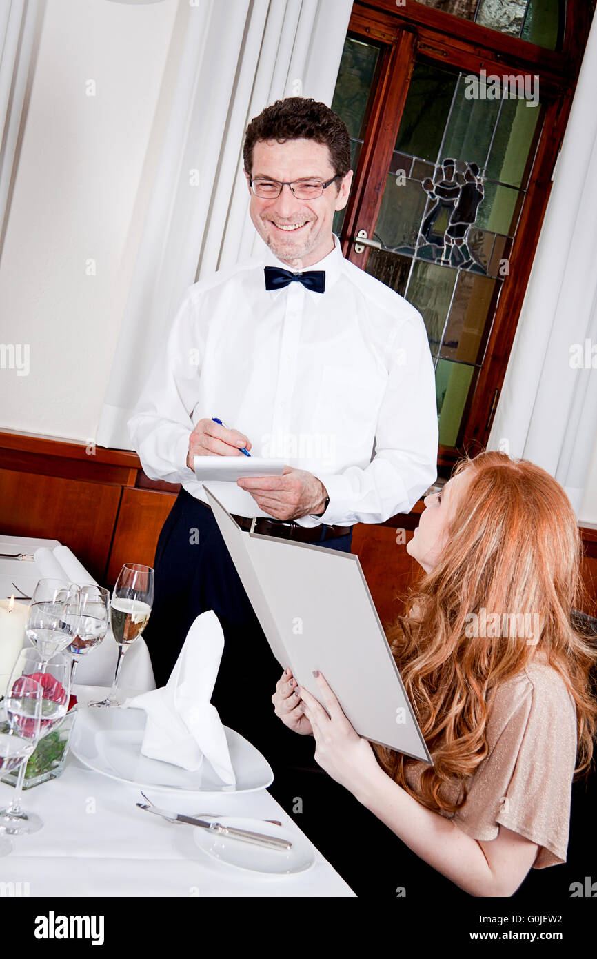 Waiter showing woman dinner table hi-res stock photography and images ...