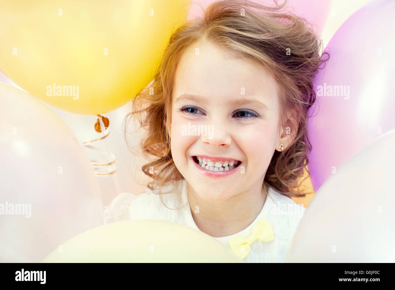 Portrait of happy child on balloons background Stock Photo - Alamy