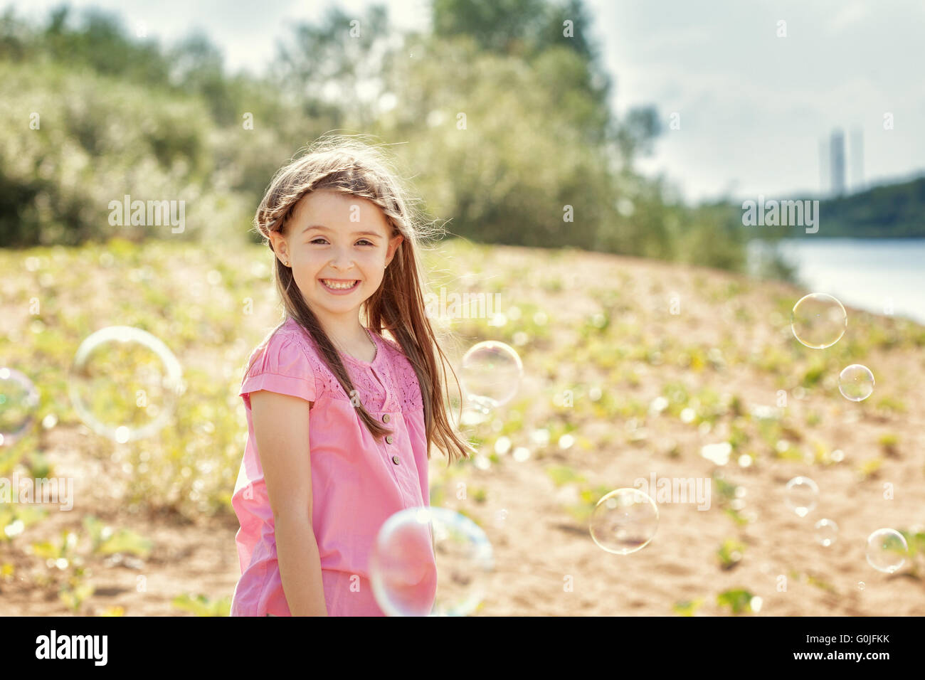 Portrait of merry little girl posing at camera Stock Photo - Alamy