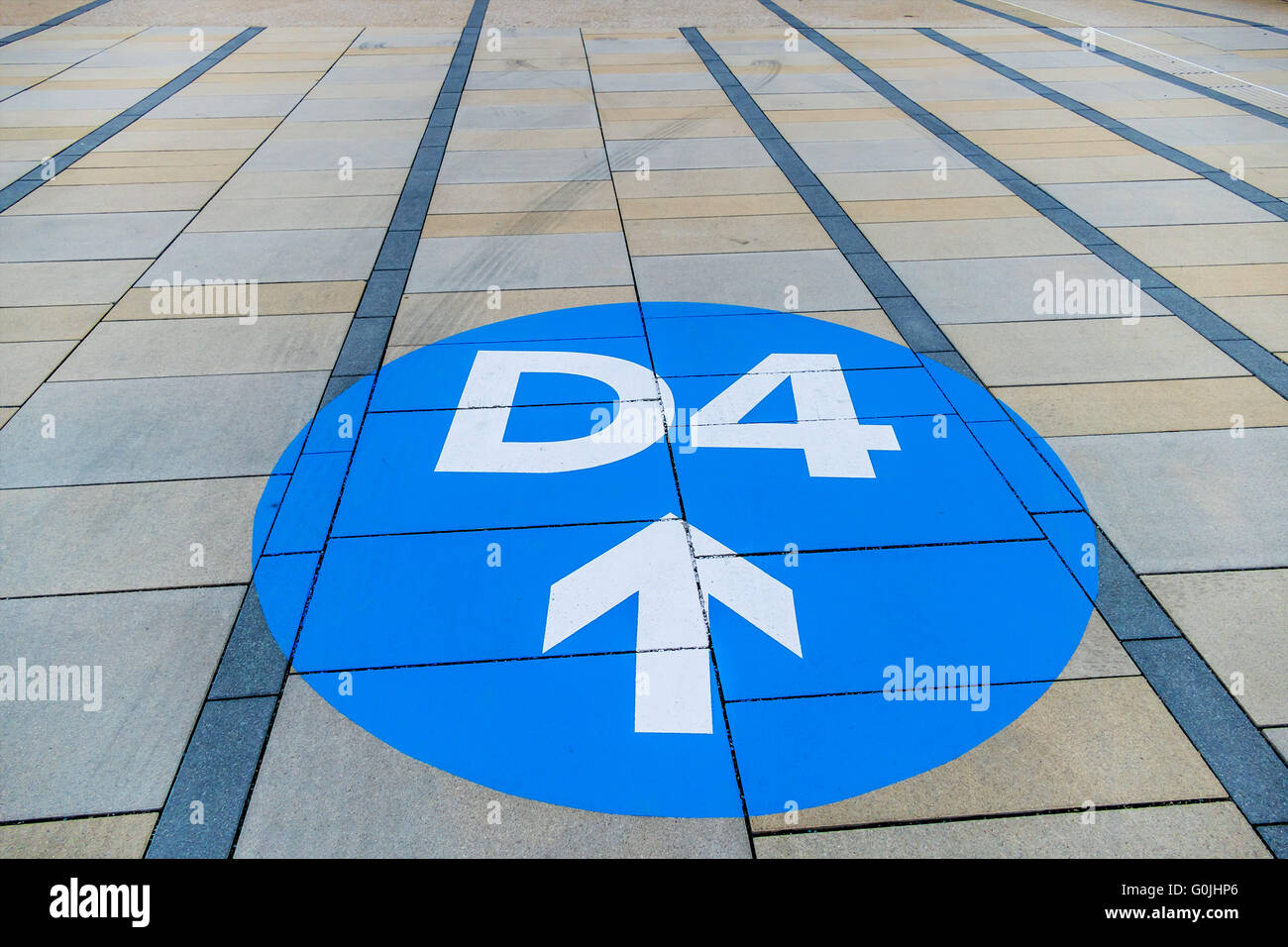 blue arrow on pavement slabs Stock Photo