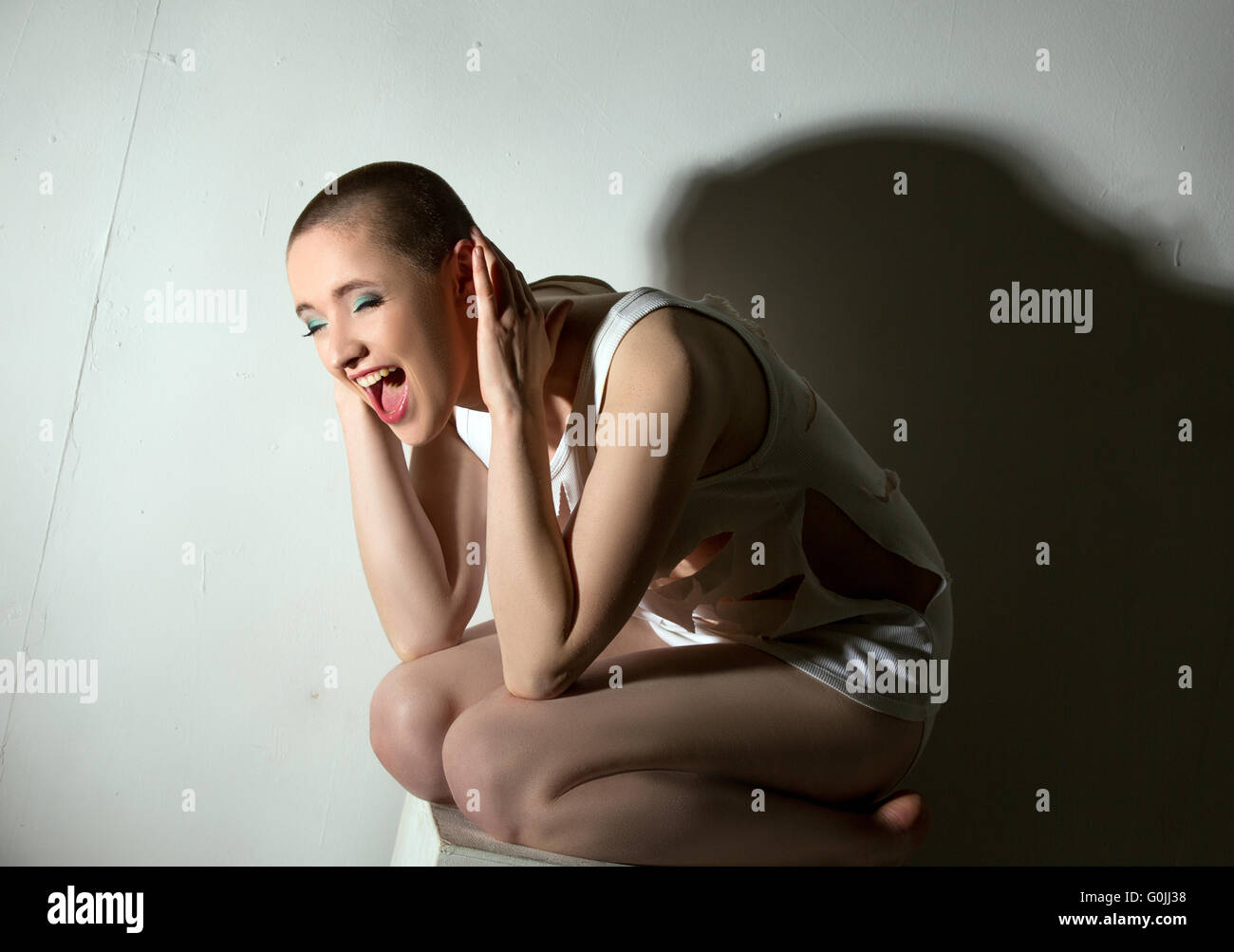 Concept of madness. Skinhead girl screaming Stock Photo