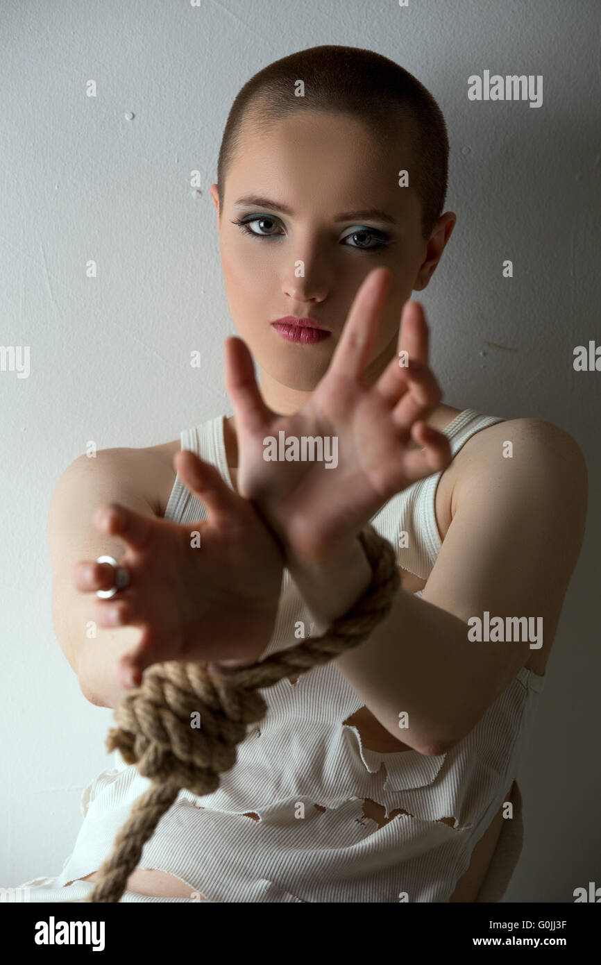 Crazy-looking girl posing with hands tied Stock Photo