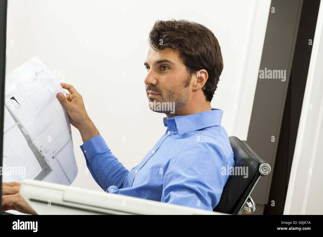 Young man reading written agreements for work Stock Photo
