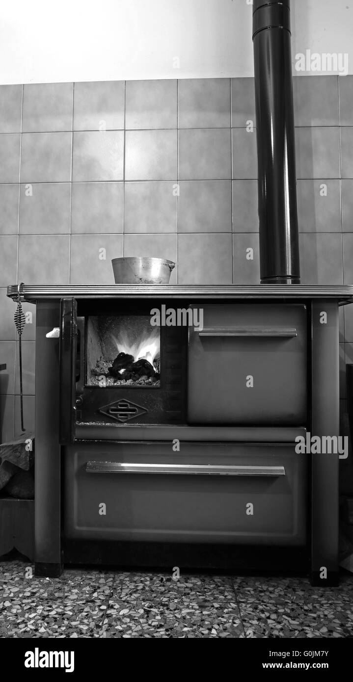 old wood-burning stove in the kitchen of mountain home Stock Photo