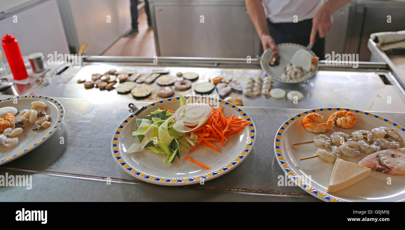 expert chef cooking foods in the kitchen of the restaurant Stock Photo