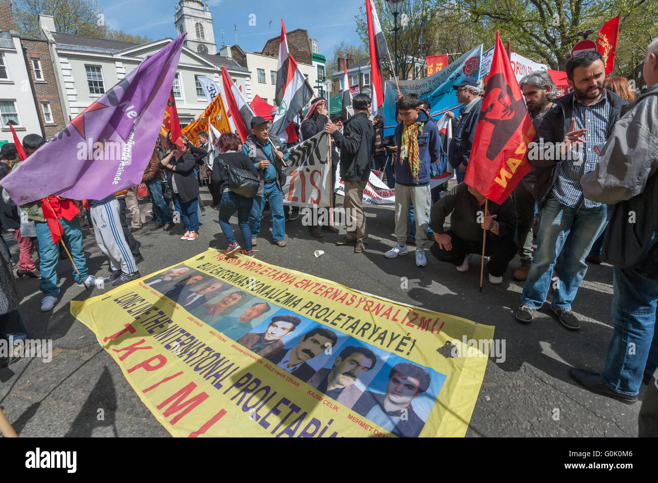 London, UK. 1st May, 2016. Socialists celebrating international Workers Day including many from London's international and migrant communities gather at Clekenwell Green before marching through London. A large banner states 'Long Live the International Proletariat' and has pictures of Marx, Engels, Lenin, Stalin, Mao and four Turkish communists. Peter Marshall/Alamy Live News Stock Photo