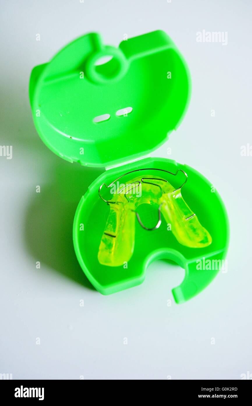 Braces for a kid laying in a special box on the sink in a bathroom