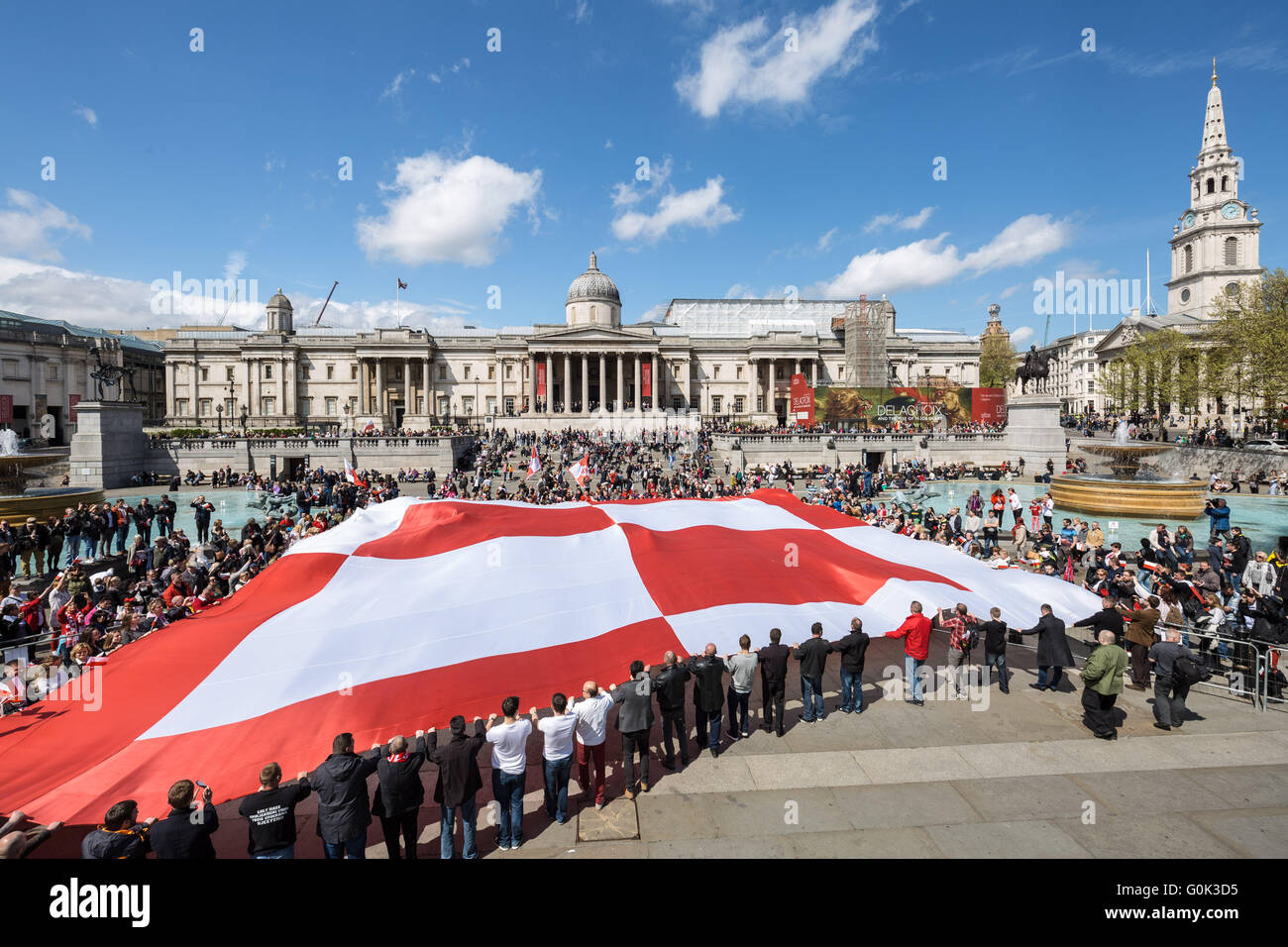 London, UK. 2nd May, 2016. British Poles celebrate National Polish Flag day in Trafalgar Square by unfurling a massive red and white checkerboard flag symbol of the Polish Air Force RAF’s 303 Squadron from WWII Credit:  Guy Corbishley/Alamy Live News Stock Photo