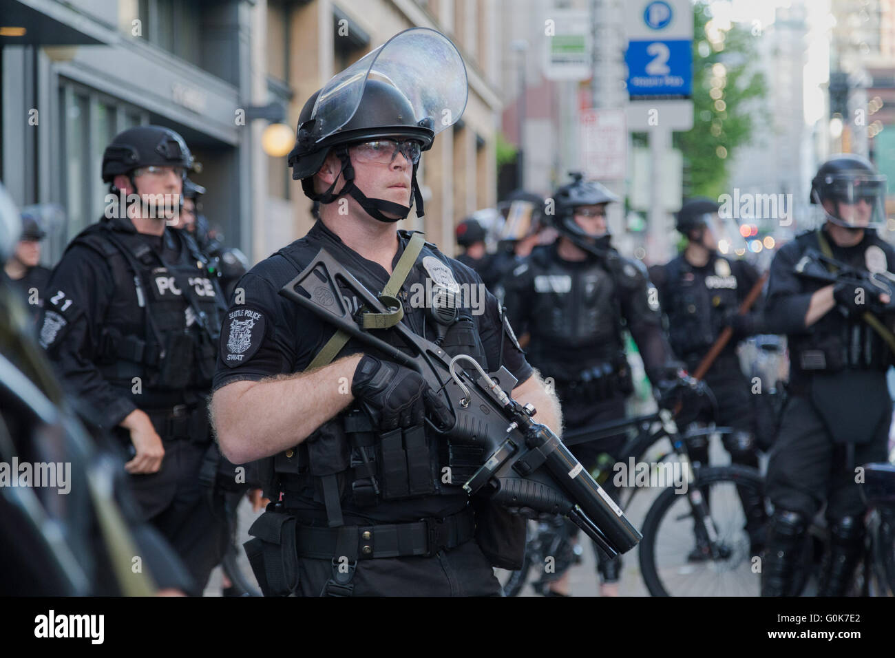 Seattle, WA, USA. 1st May,2016. Officers with non-lethal crowd dispersal device look over protesters marching in downtown. Maria S./Alamy Live news Stock Photo