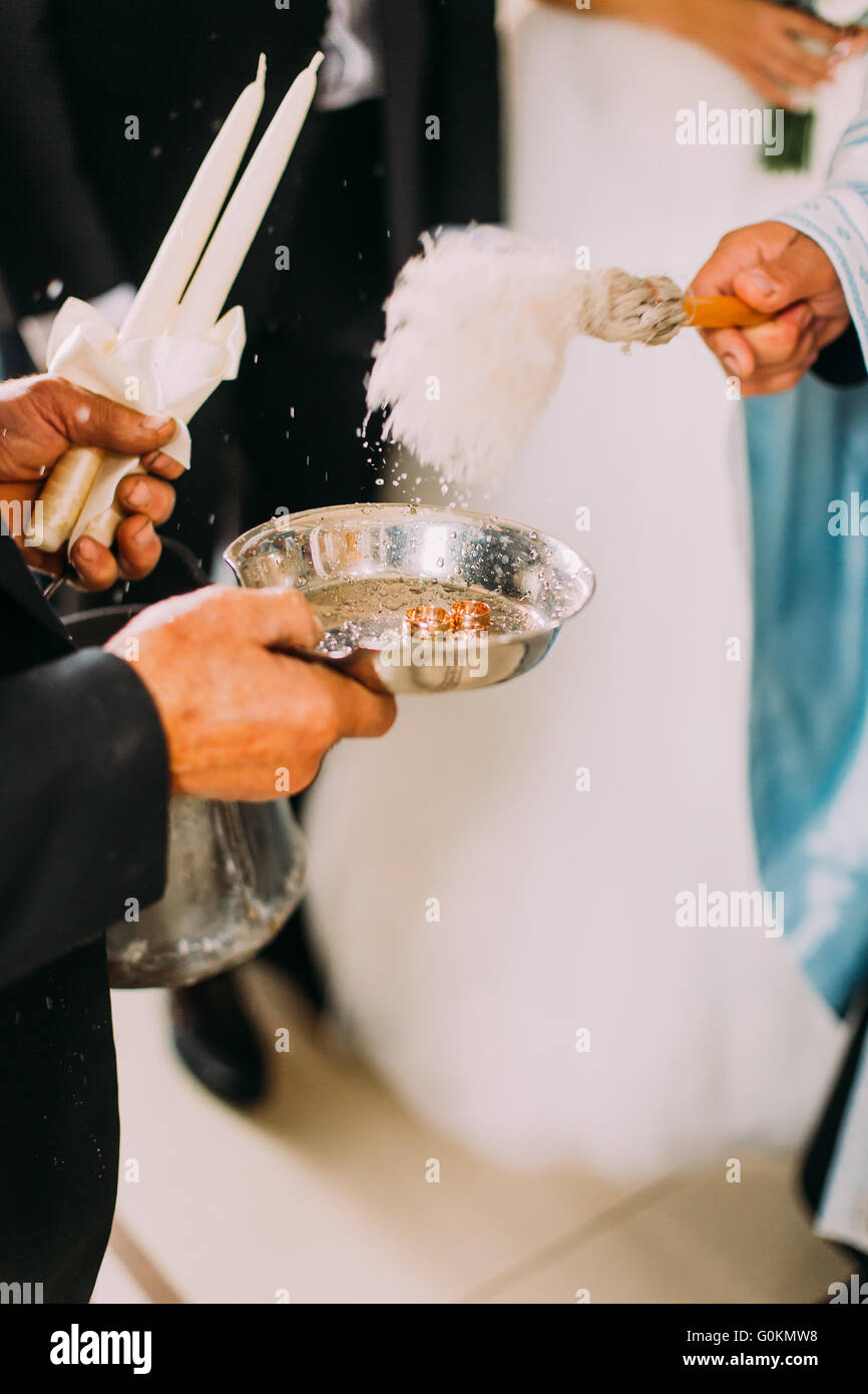 Priest blessing luxury wedding rings in the old church Stock Photo Alamy