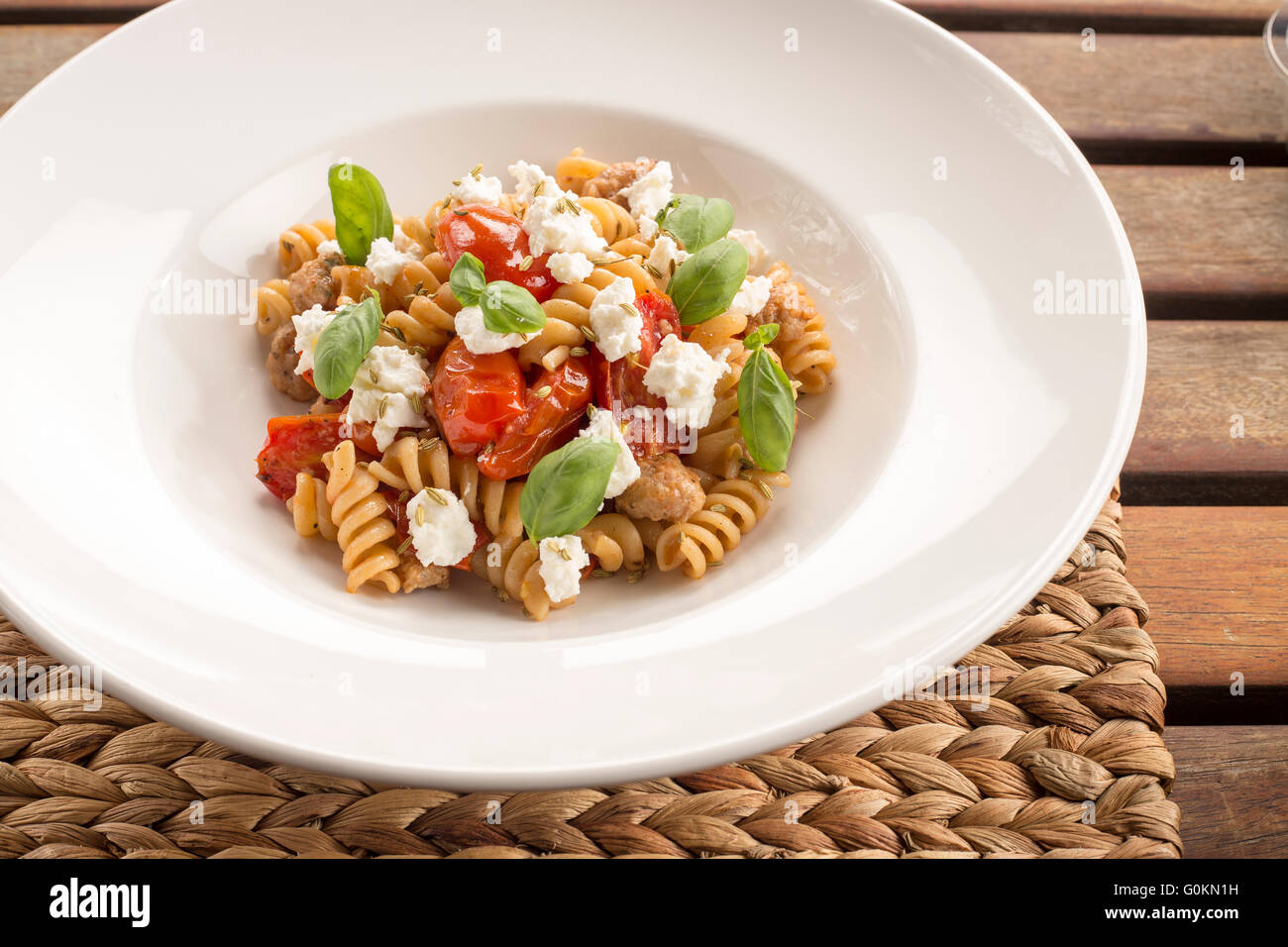 Pasta with Italian sausage, San marzano tomatoes, ricotta, chilli & fennel seeds Stock Photo