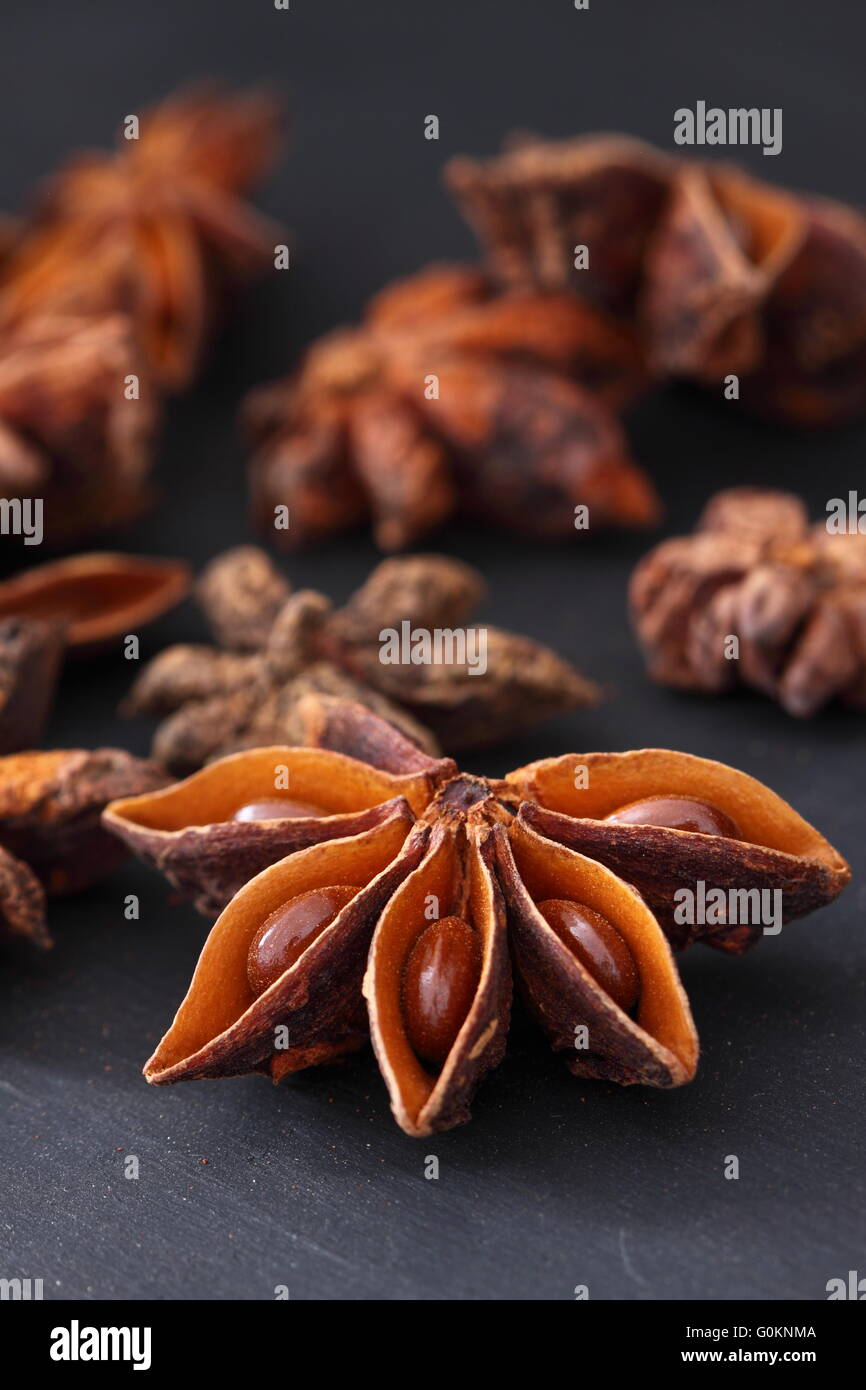 Star Anise on a black wood background Stock Photo