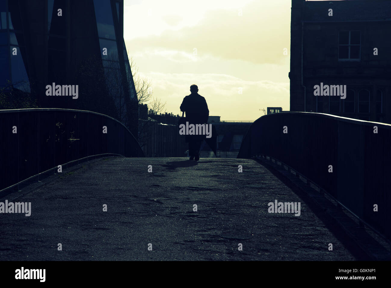Cityscape silhouette of man with railings in Glasgow Stock Photo