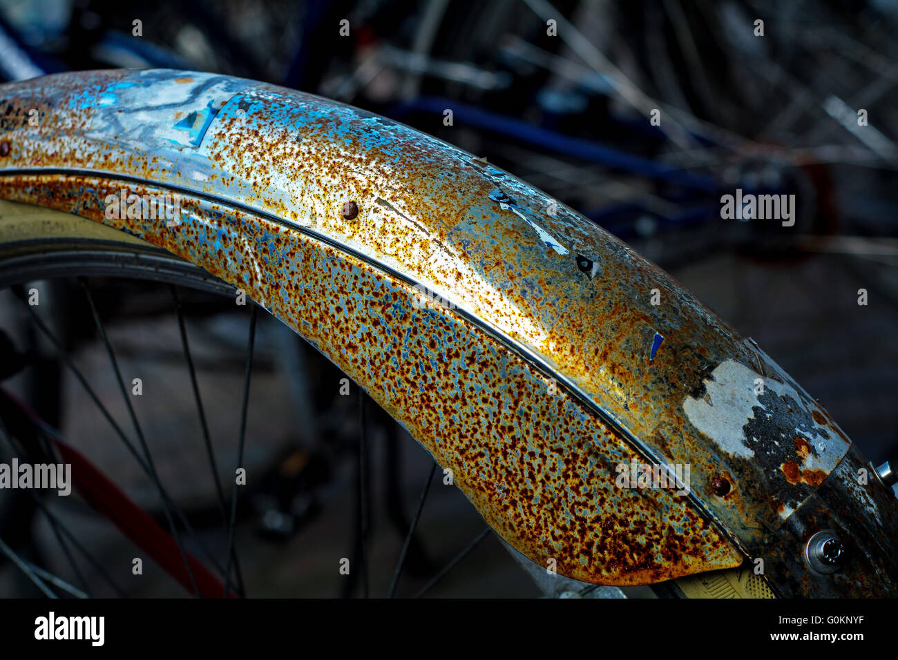 bicycle mudguard with rust and remnants of stickers, detail, abstract  background Stock Photo