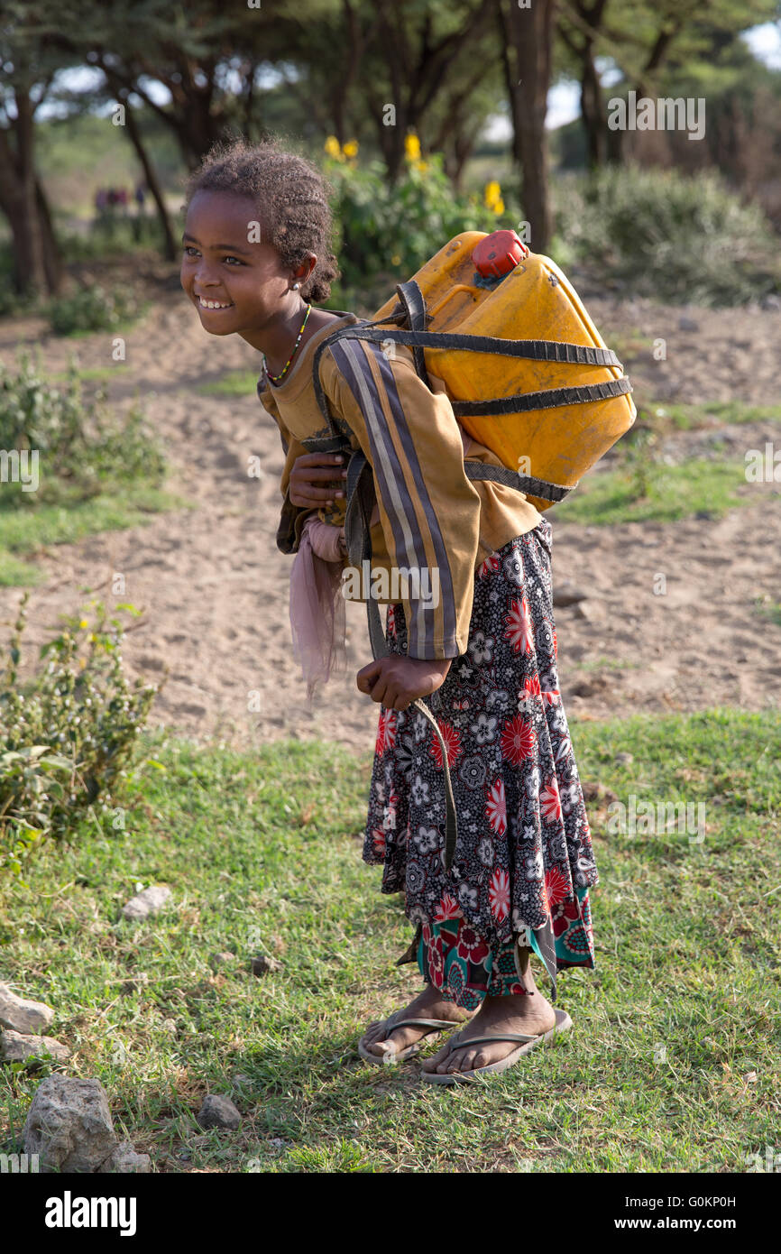 Lake Langano, Ethiopia, October 2013 Lomi Aman, 9, carries water 1.5km home every day. She goes to school in the morning. Stock Photo