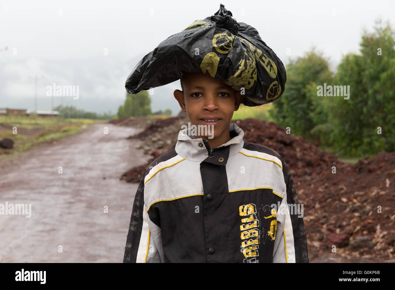 Gurage, Ethiopia, October 2013 A boy keeps his books dry in a plastic