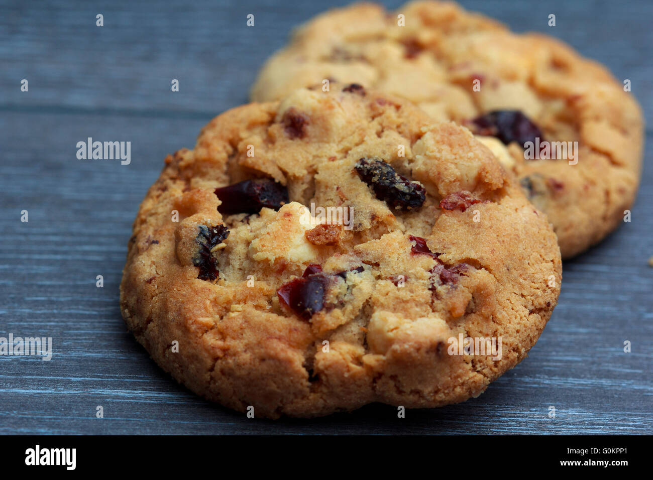 White chocolate and cranberries on rustic wooden table Stock Photo