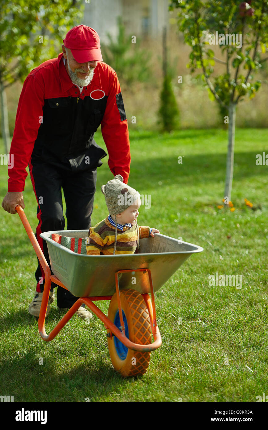 cute little boy sitting in wheelbarrow Stock Photo - Alamy