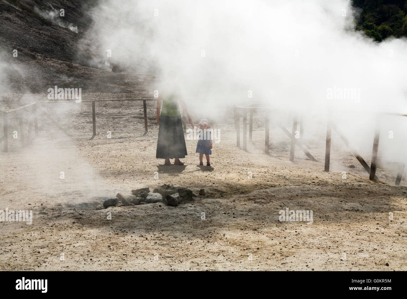Tourist woman & child / family at Solfatara volcano steam & sulfurous fumes Pozzuoli, Naples Italy; Campi Flegrei volcanic area Stock Photo