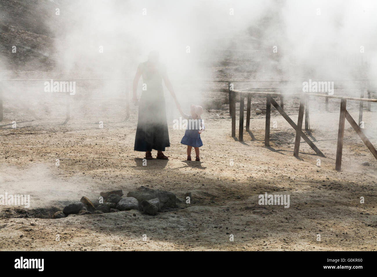 Tourist woman & child / family at Solfatara volcano steam & sulfurous fumes Pozzuoli, Naples Italy; Campi Flegrei volcanic area Stock Photo