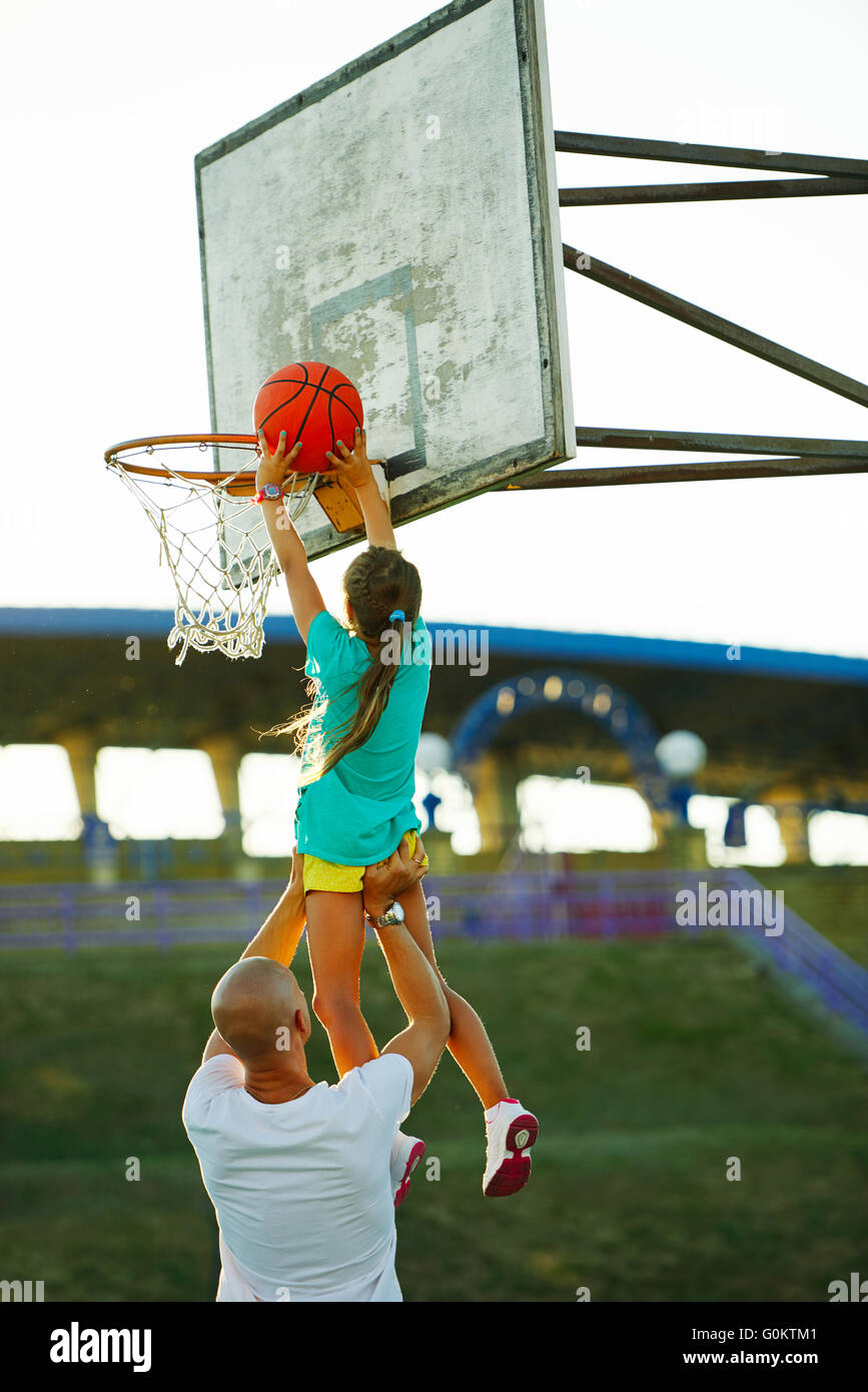 father and daughter playing basketball Stock Photo