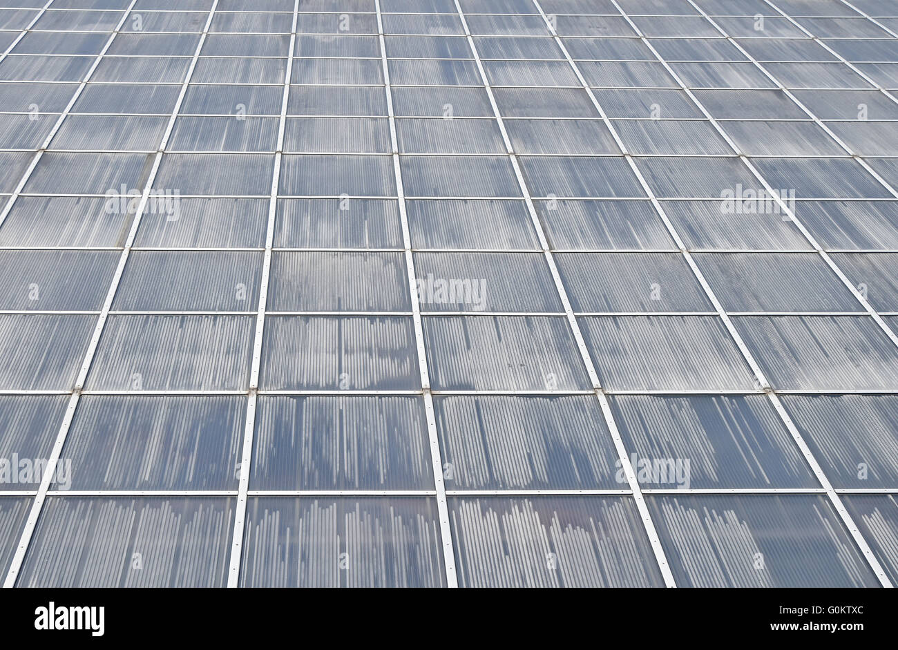 Greenhouse plastic glass framed wall of windows fog up surface in perspective Stock Photo
