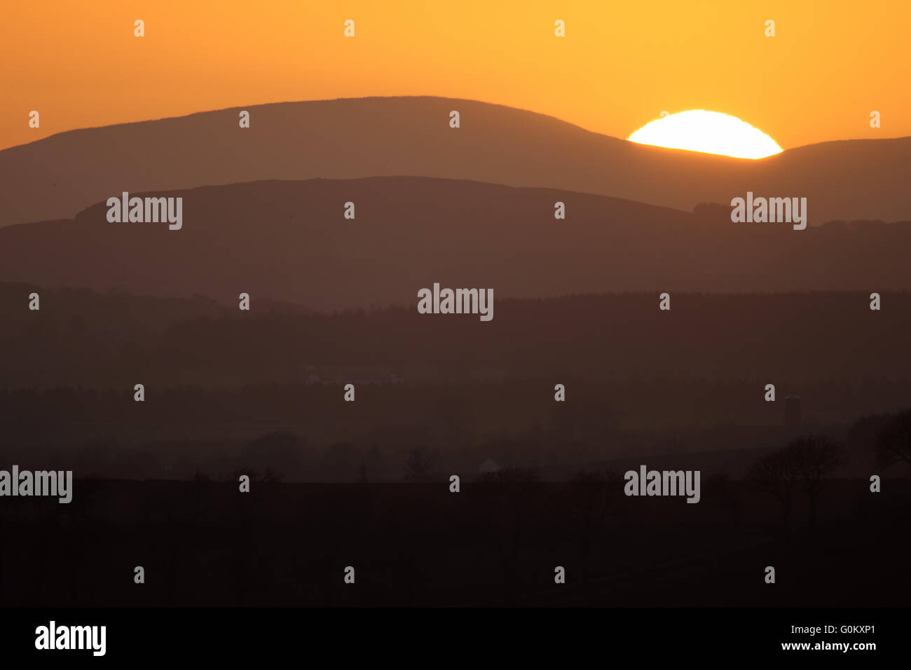 Sunset over the Angus Hills, Scotland. Viewed from Ethie. Stock Photo