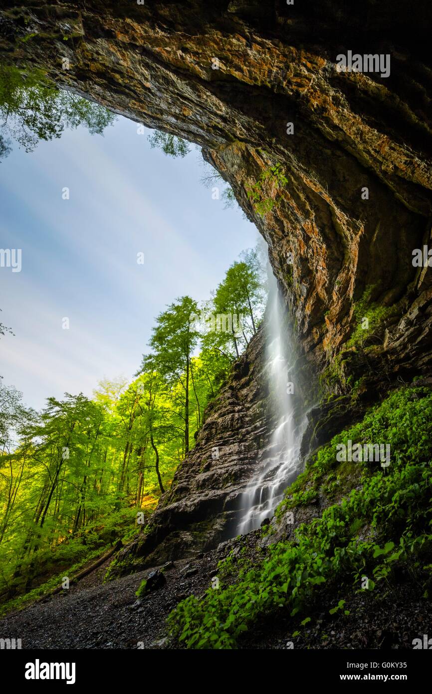 Waterfall in big cave Zeleni vir in Croatia cave steep sky circular rocky beautiful Stock Photo