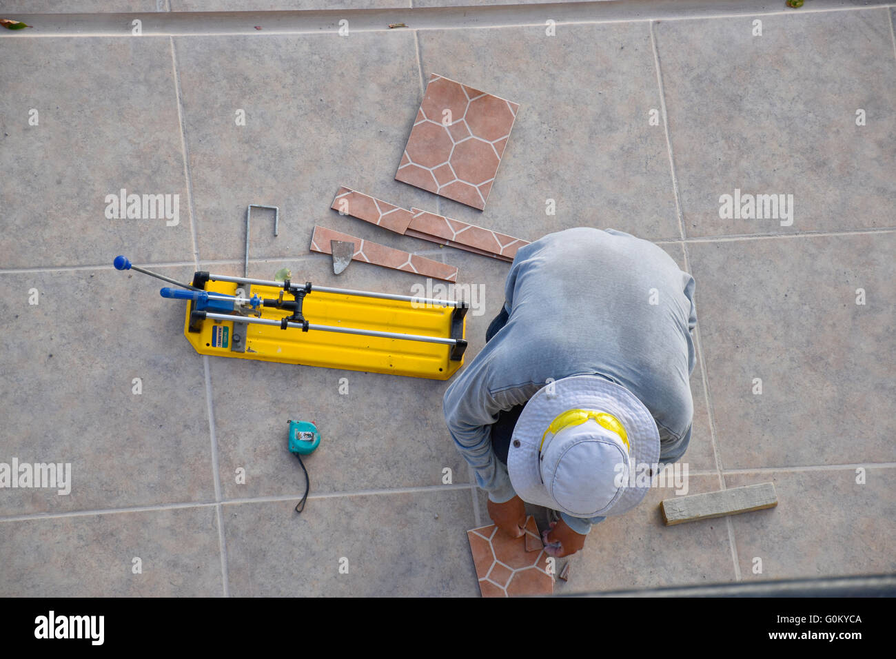 Hispanic Mexican Man Cutting Clay Tile On Tilecutter In Mexico