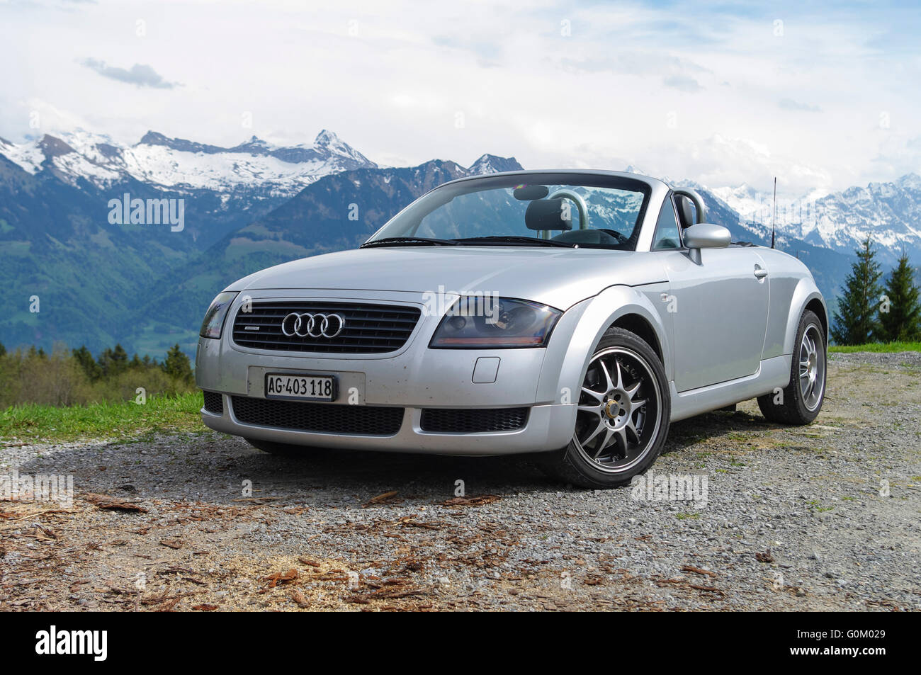 1999 Audi TT quattro roadster mark I (type 8N), silver metallic, roof retracted, in front of an Alpine backdrop. Stock Photo