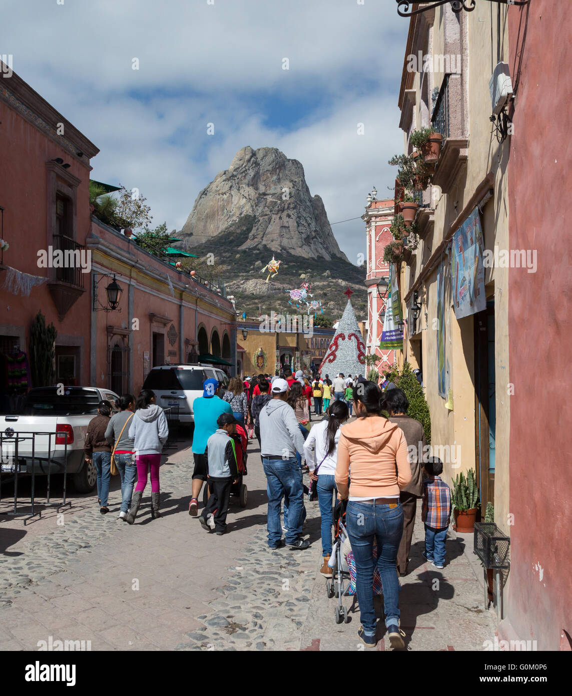 Tourists near Pena de Bernal, a large monolith standing 350 meters, is found in Pueblito Magico of Bernal, Queretaro, Mexico Stock Photo