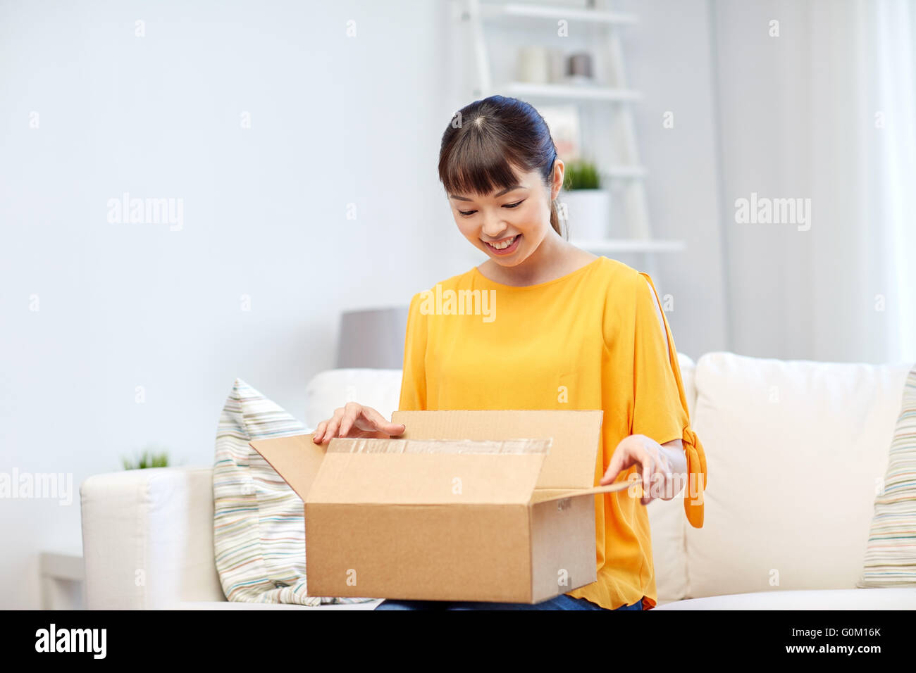 happy asian young woman with parcel box at home Stock Photo - Alamy