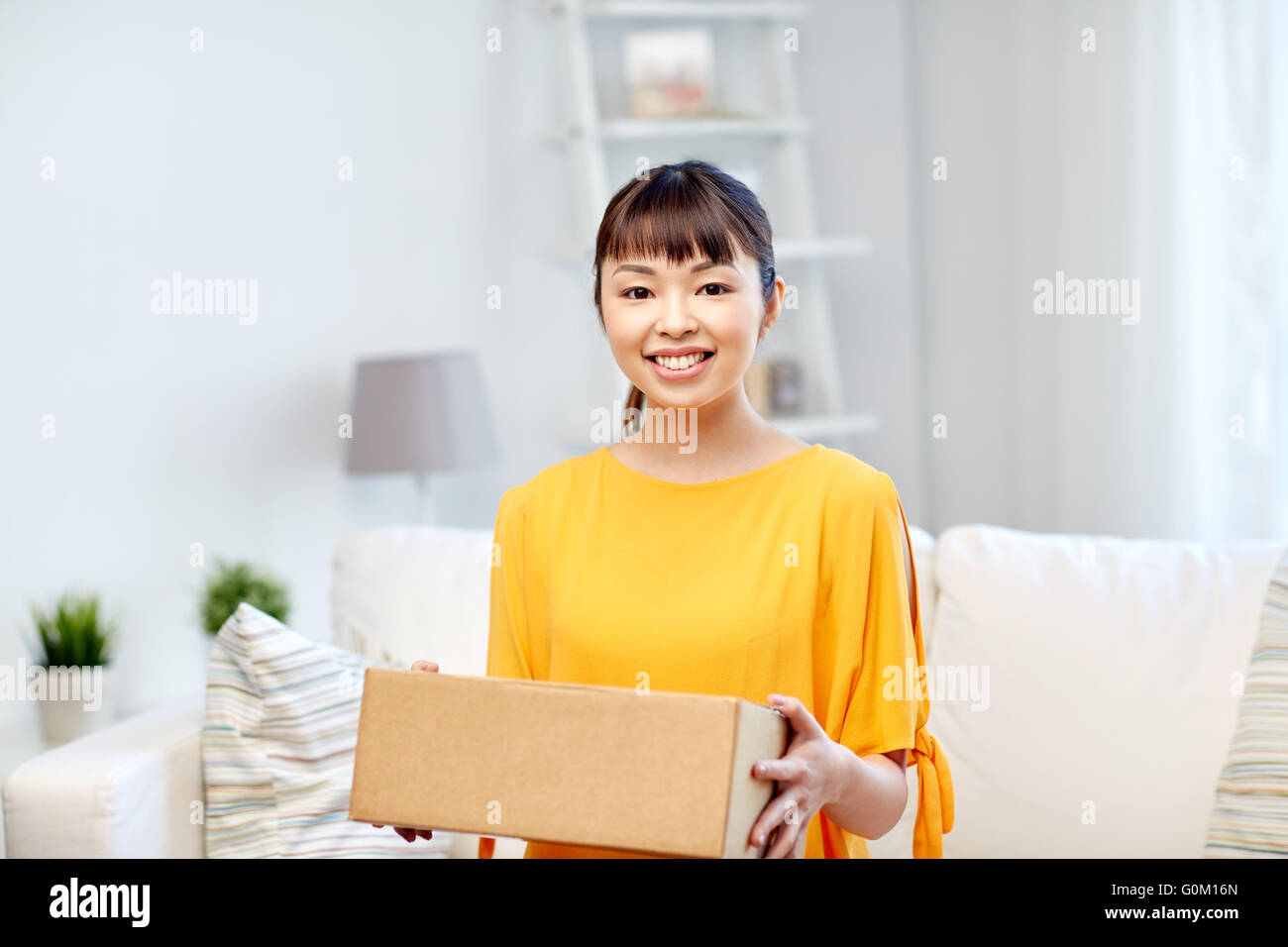 happy asian young woman with parcel box at home Stock Photo - Alamy