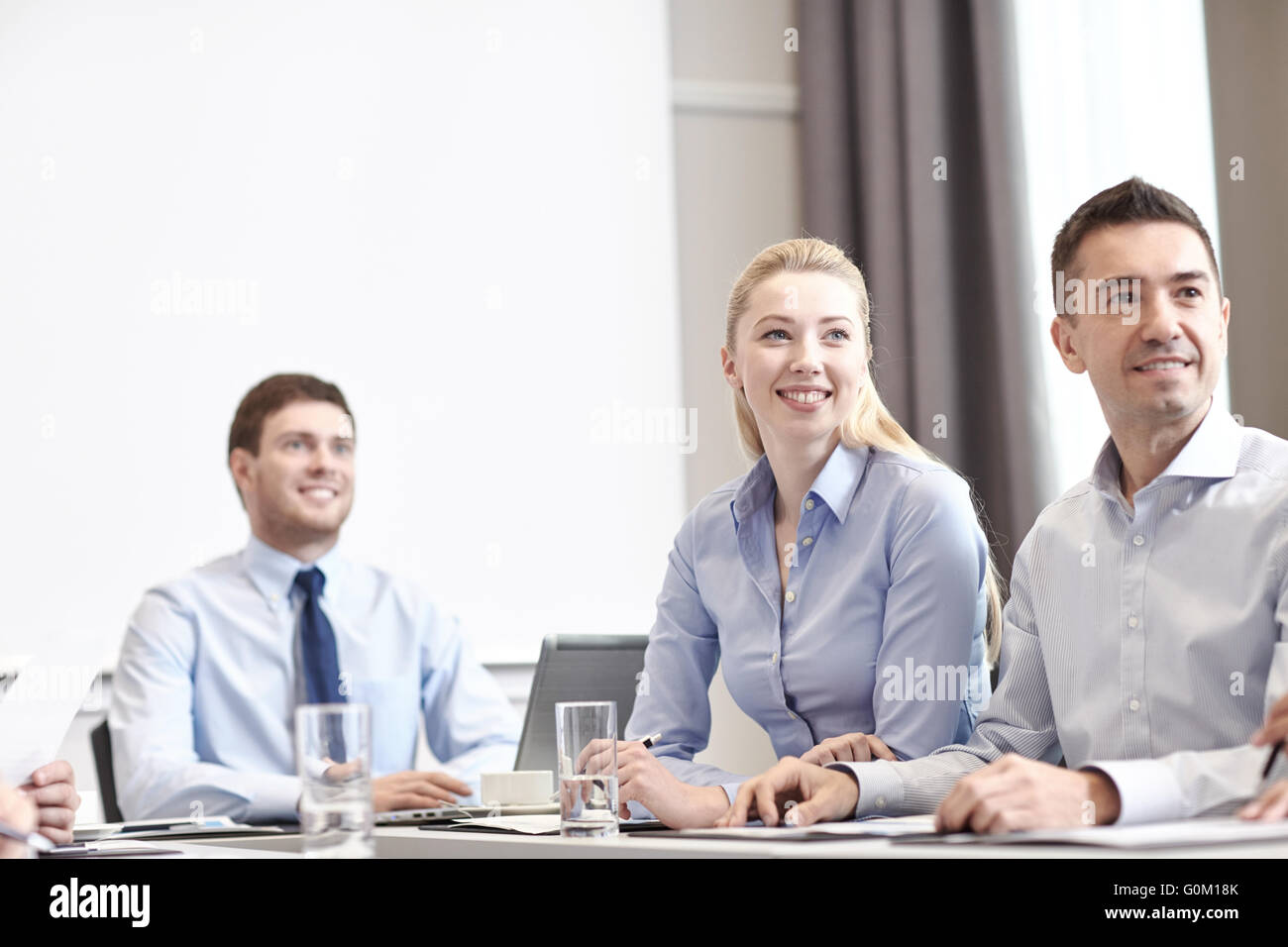 group of smiling businesspeople meeting in office Stock Photo - Alamy