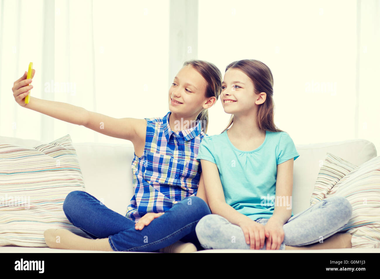 happy girls with smartphone taking selfie at home Stock Photo - Alamy