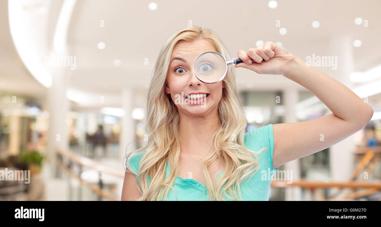 happy young woman with magnifying glass Stock Photo - Alamy