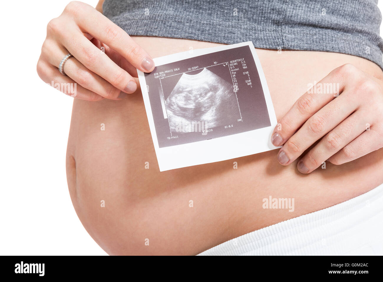 Pregnant woman displaying a prenatal ultrasound Stock Photo