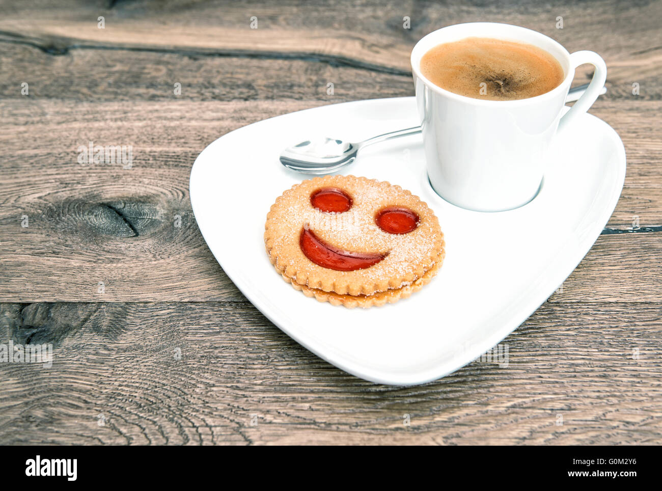 Cup of coffee with smiley face cookie on wooden background. Funny breakfast  Stock Photo - Alamy, image size:1300x964