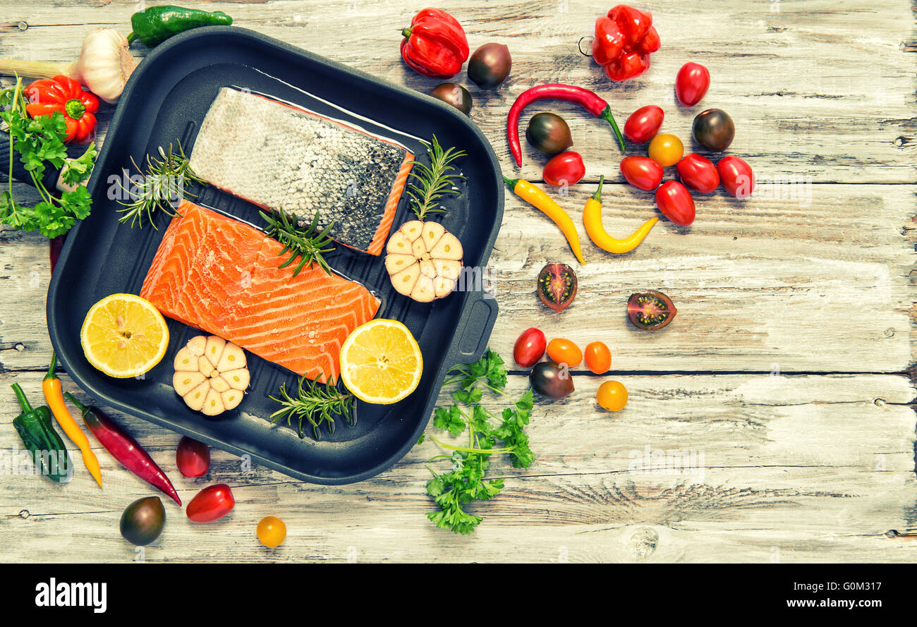 Salmon fish fillet with herbs and vegetables. Flat lay food background ...