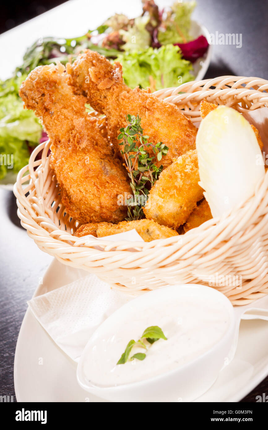 Crisp crunchy golden chicken legs and wings Stock Photo