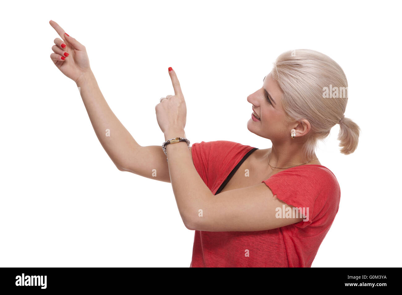Happy Blond Woman Pointing Up with Both Hands Stock Photo