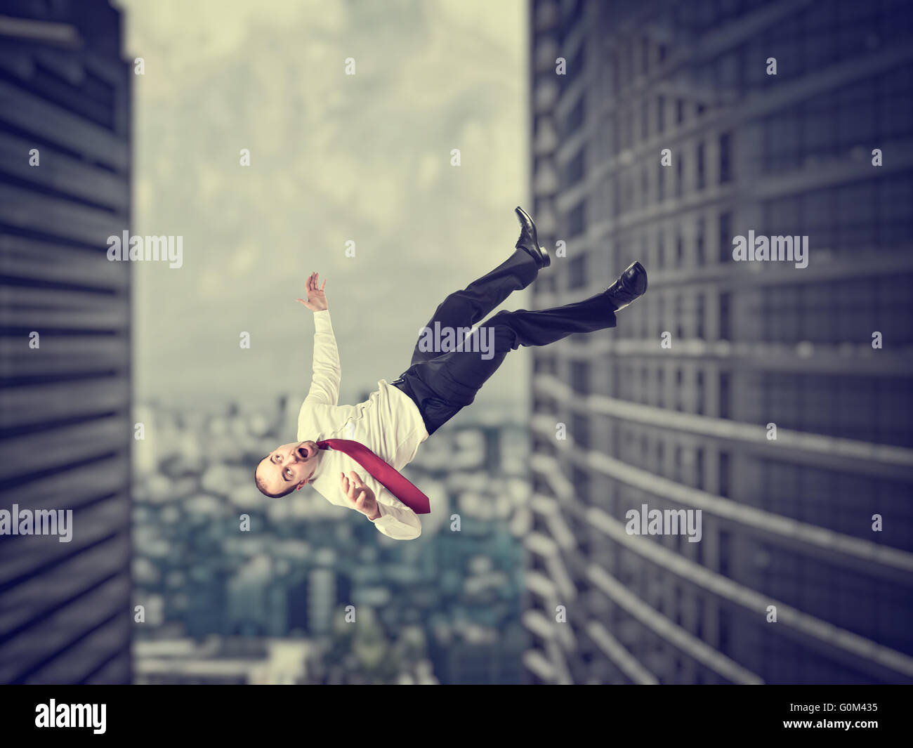 falling businessman and modern urban background Stock Photo