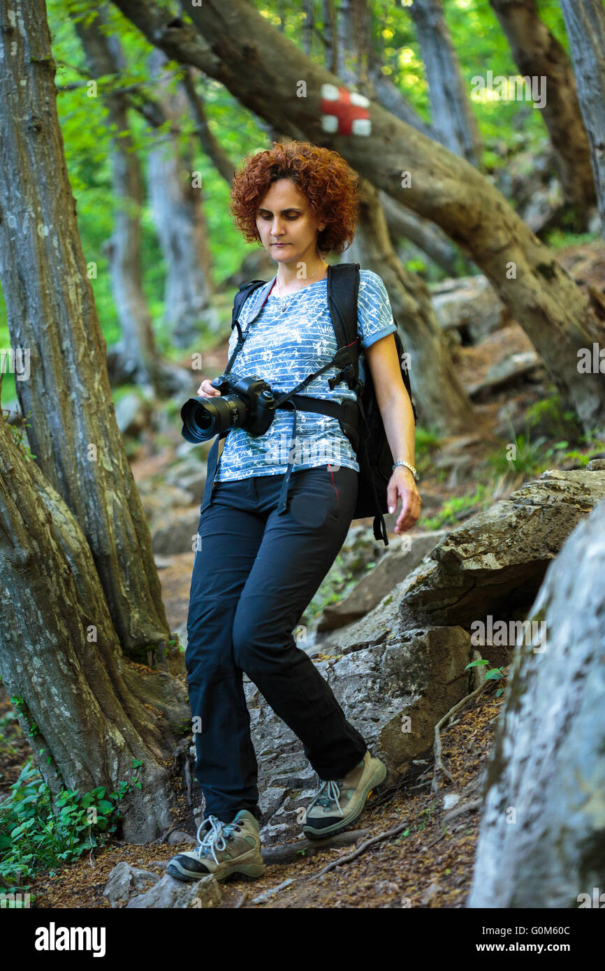 https://c8.alamy.com/comp/G0M60C/woman-hiker-with-backpack-trekking-into-the-woods-on-a-mountain-trail-G0M60C.jpg