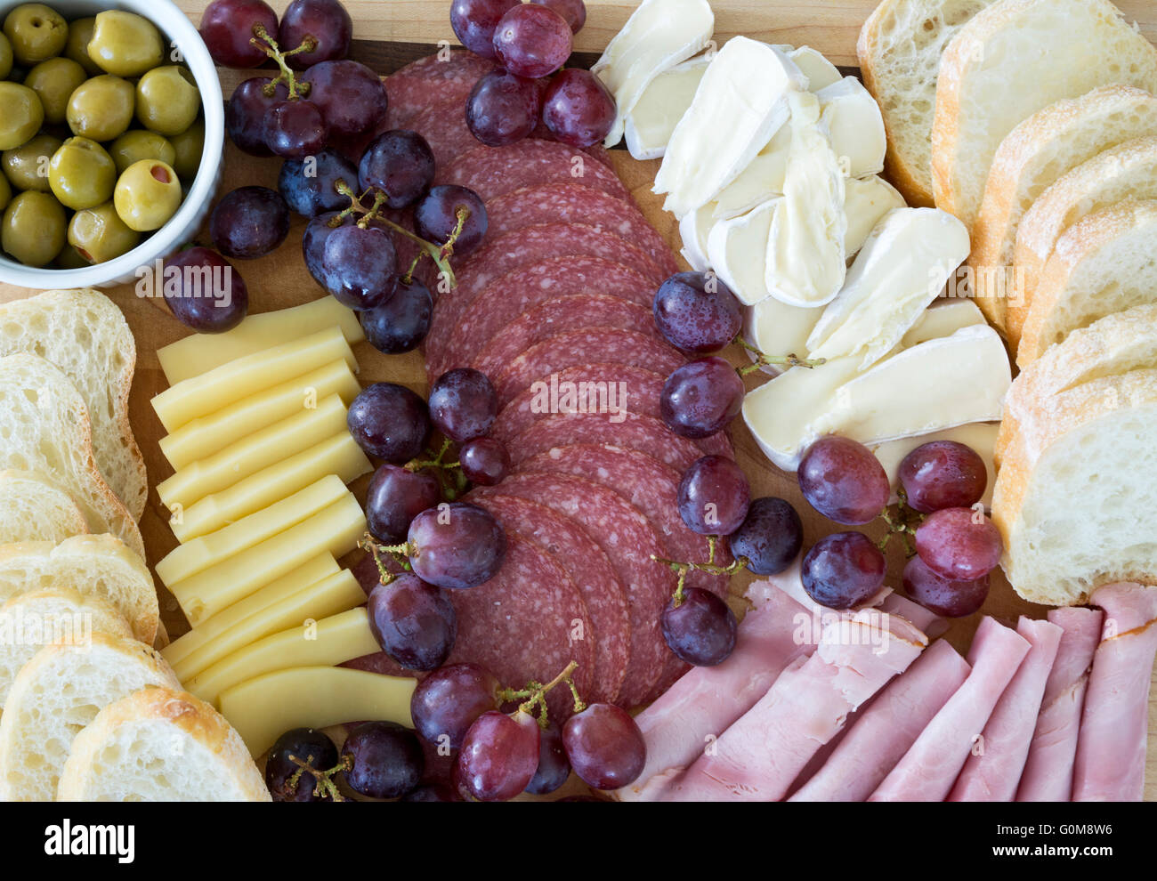 Charcuterie platter with meats, cheeses, bread and olives. Meat and