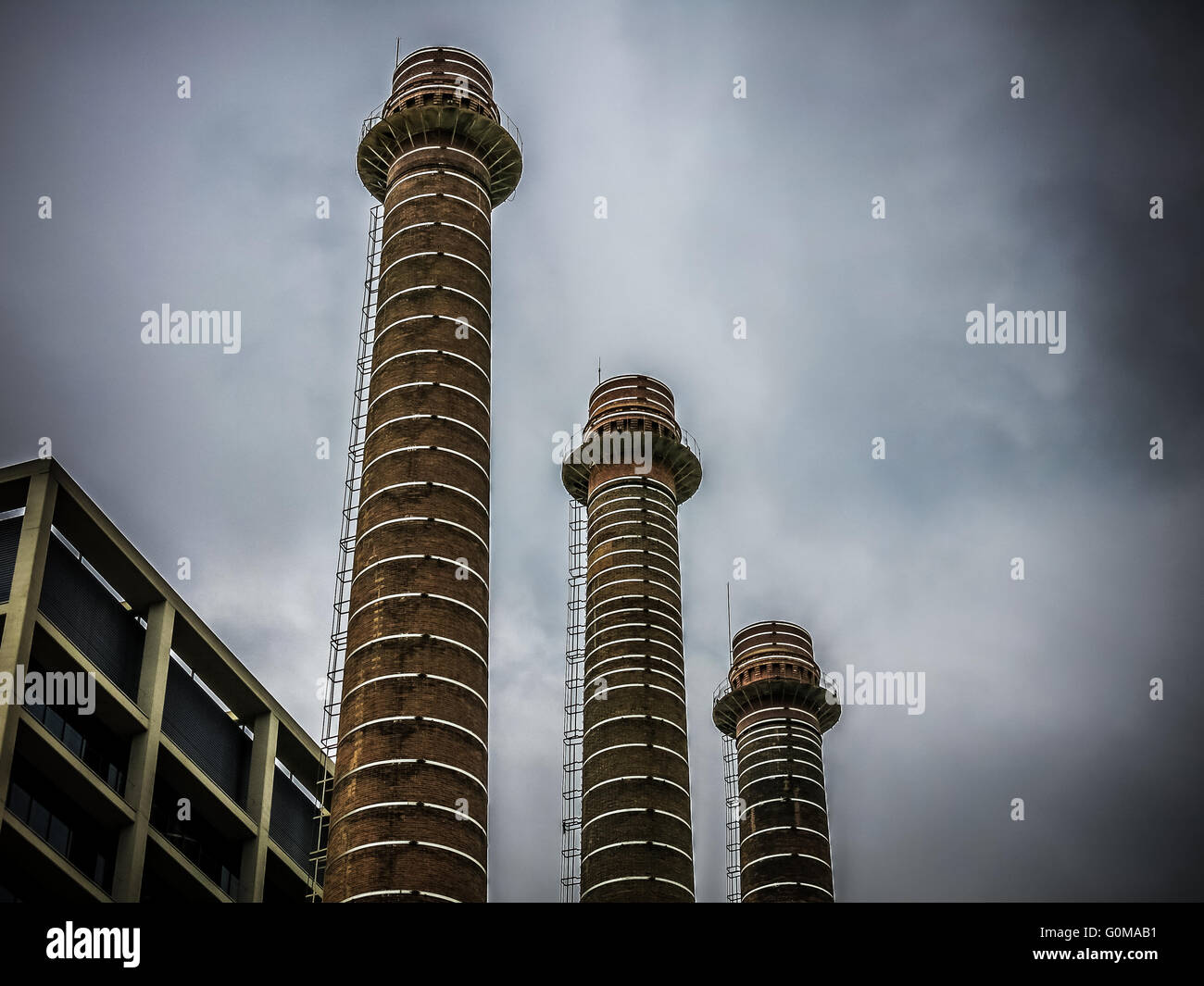 Three chimneys of former electrical plant Canadenca. Example of old industrial architecture in Poble Sec district of Barcelona, Stock Photo