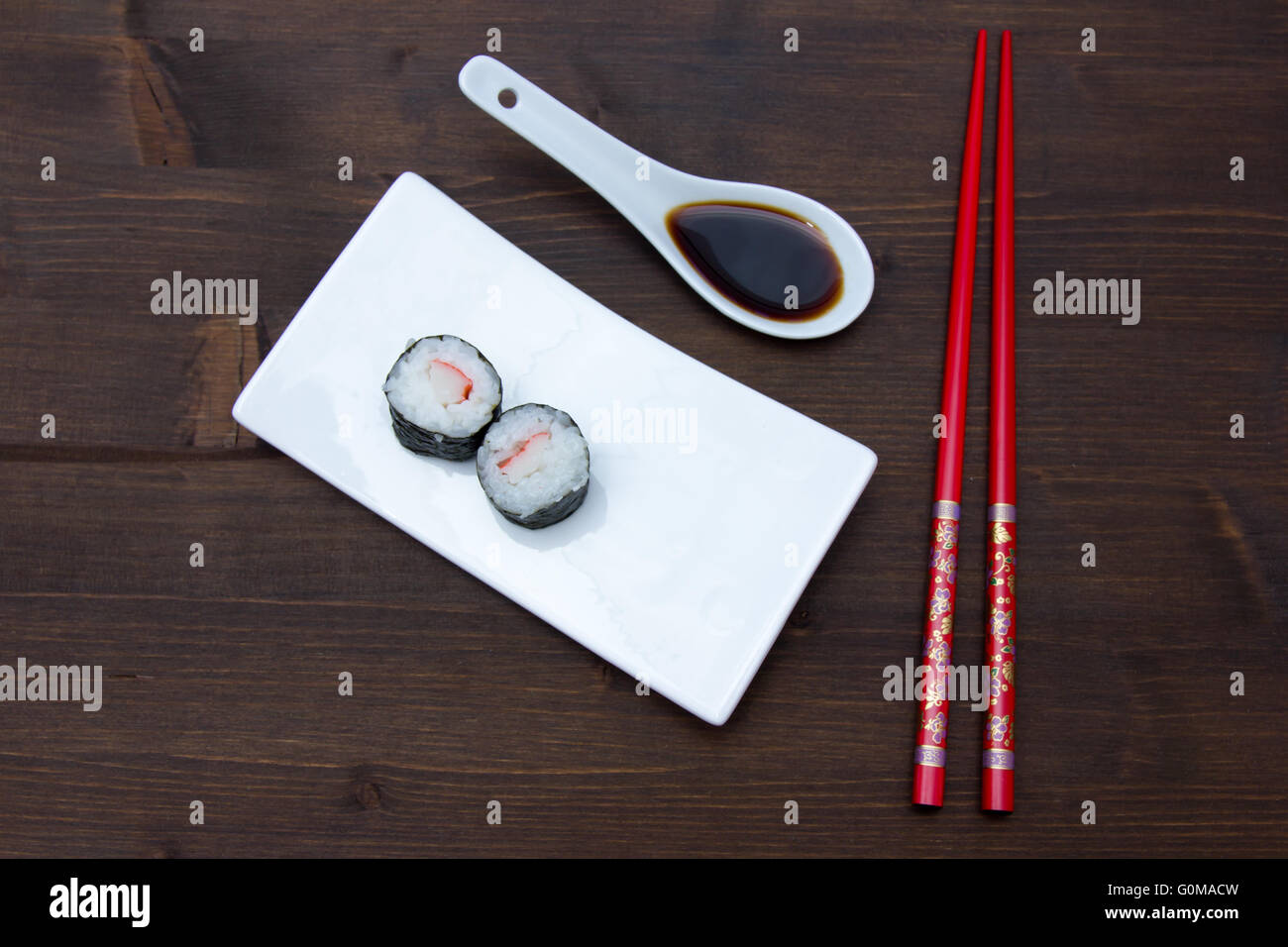 Maki with surimi on a wooden table seen from above Stock Photo