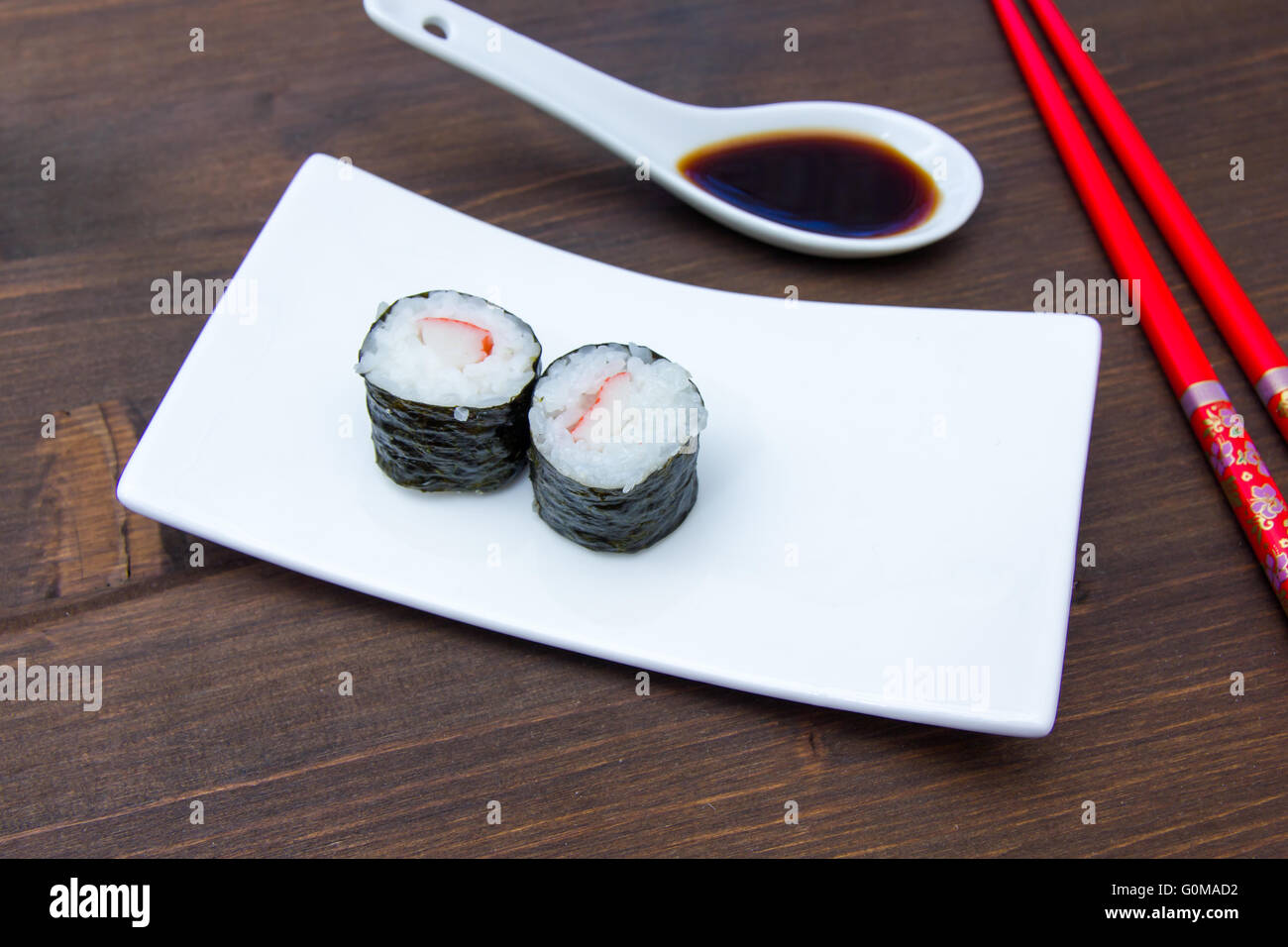 Maki with surimi on a wooden table seen up close Stock Photo