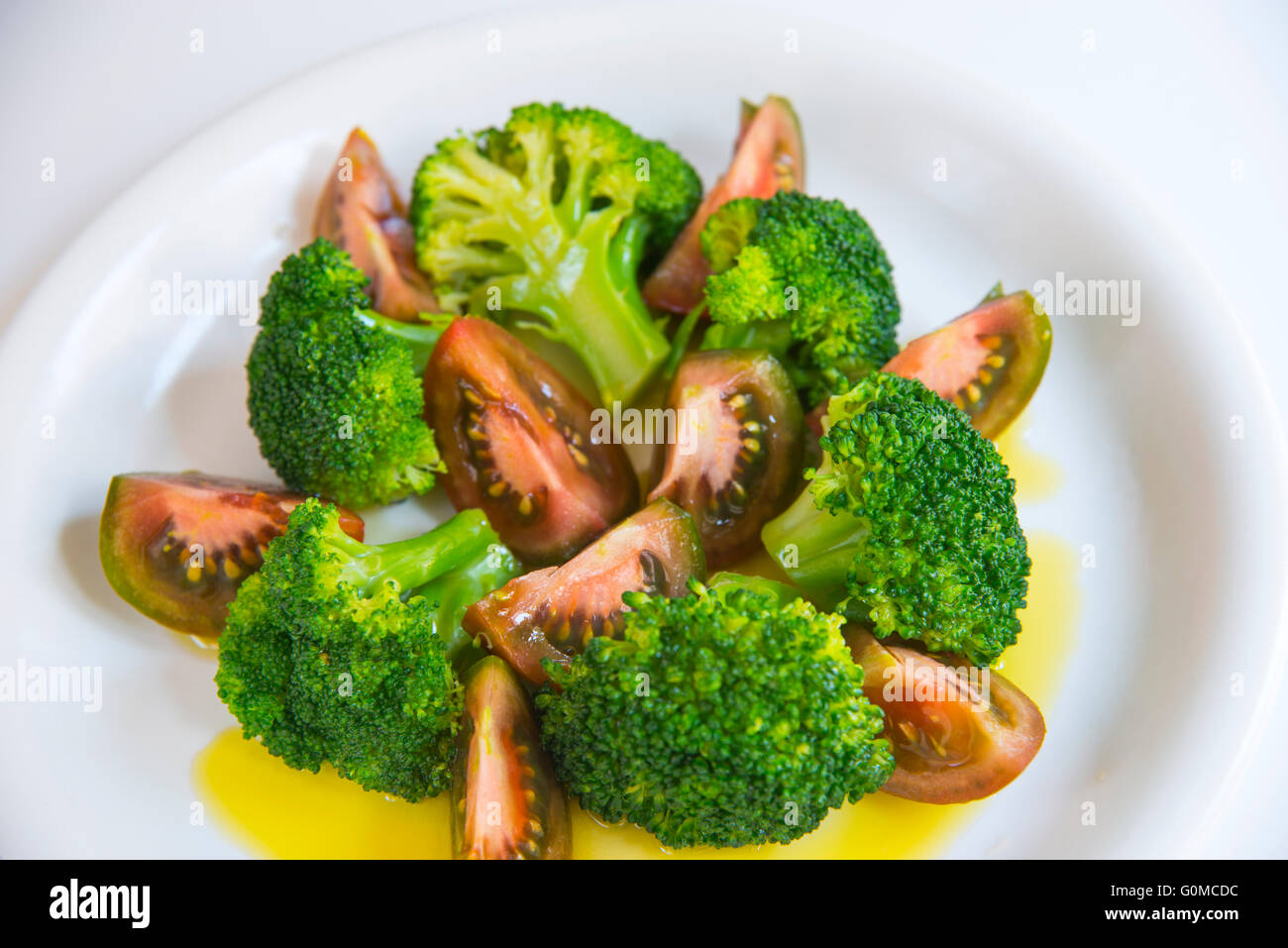 Salad made of broccoli, tomato and olive oil Stock Photo Alamy
