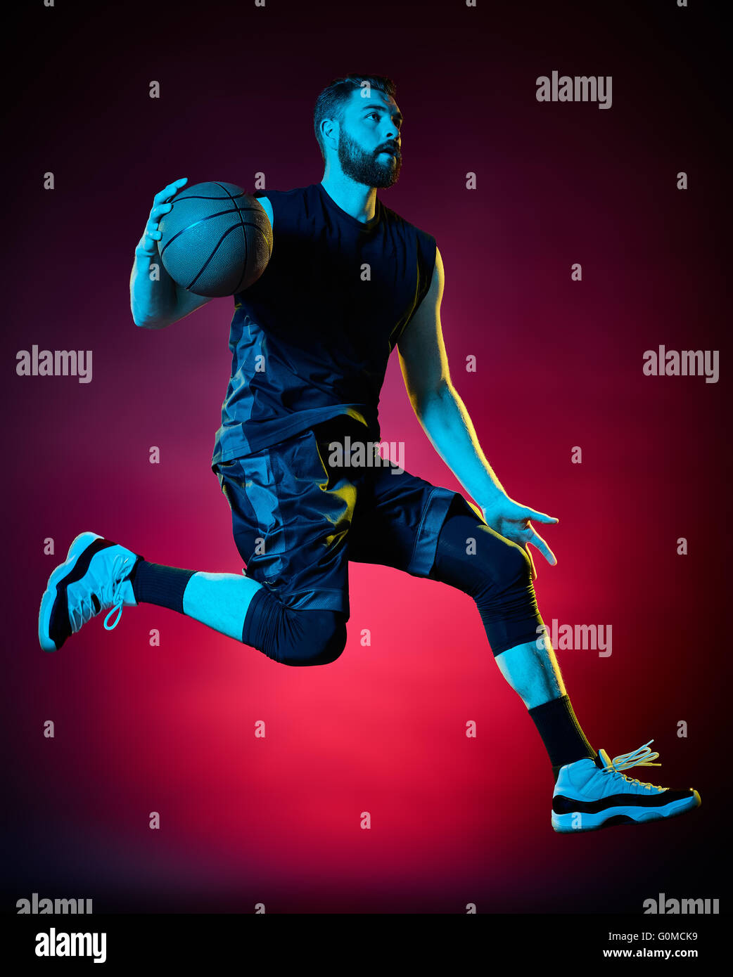 one basketball player man Isolated on black background Stock Photo