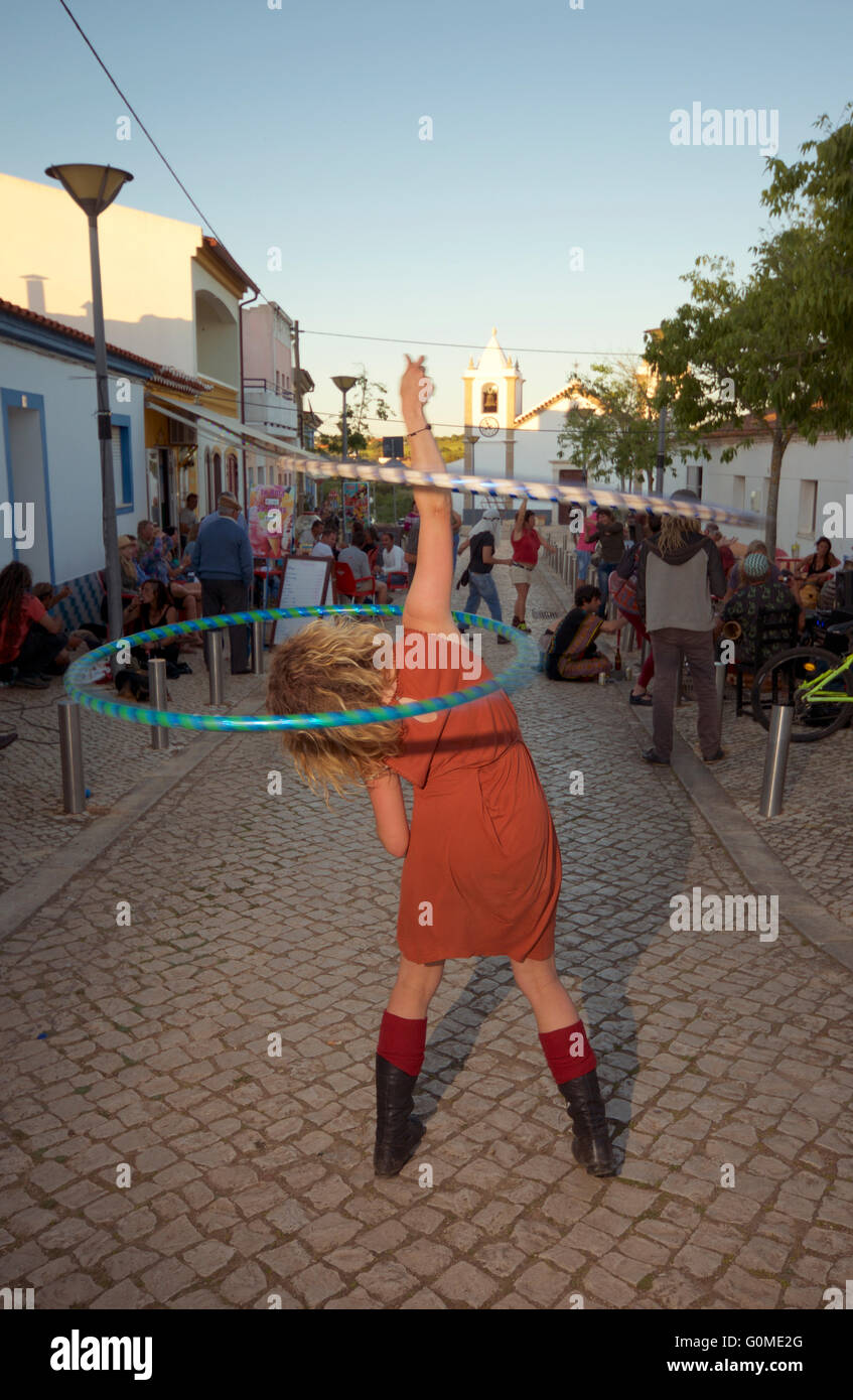 Girl with double hula hoop at a street party, Barao de Sao Joao, Algarve Portugal Stock Photo